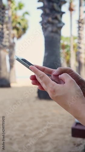 Woman using smartphone on tropical beach, mobile communication and travel lifestyle