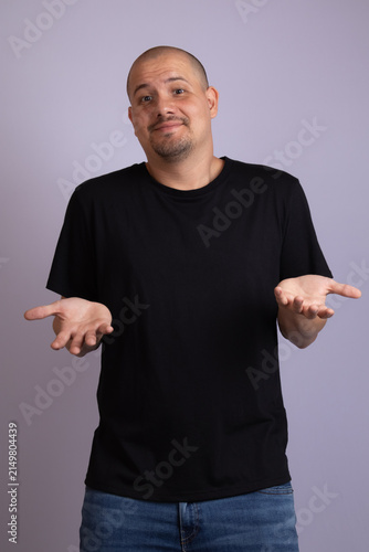 Bild auf Leinwand Confused latino man shrugging shoulders with open hands