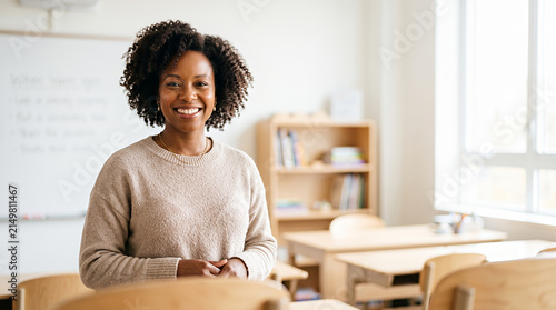 Woman educator standing confidently in modern classroom setting