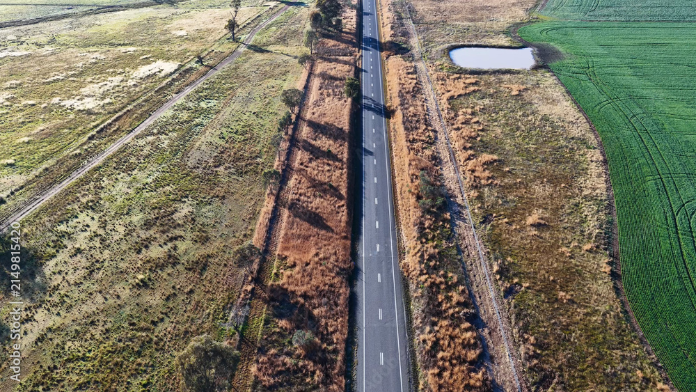 Obraz premium Aerial View of Straight Asphalt Road Through Rural Australian Farmland