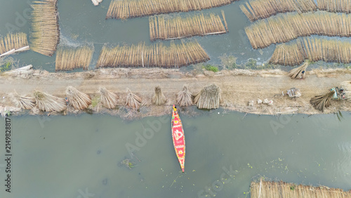 Jute bundles float on Bortir Bil in rural India, reflecting traditional livelihoods and sustainable agriculture. Jute, a natural biodegradable fiber, offers an eco-friendly alternative to plastic. 