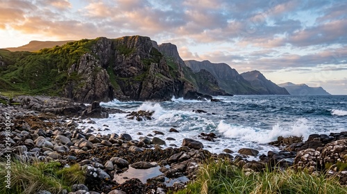 Beautiful sunset over the ocean waves crashing against the rocky cliff shore in scotland