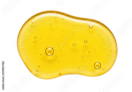 A single drop of sweet golden honey dripping or splashing