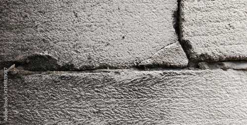 Damaged and cracked concrete block masonry wall texture
