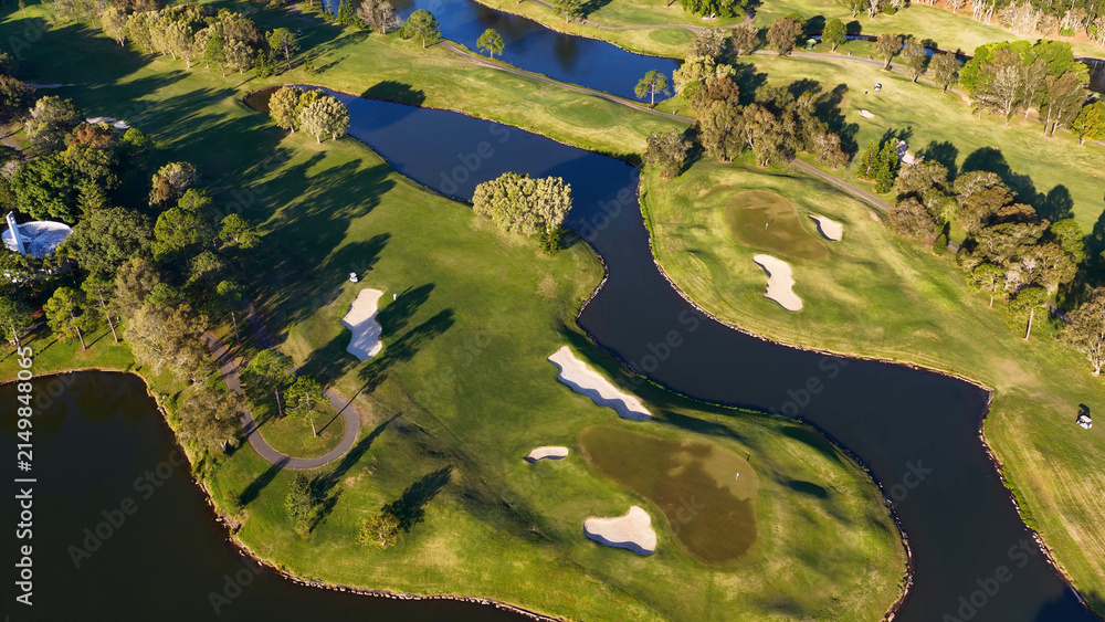 Fototapeta premium Aerial View of Lush Green Golf Course Fairways and Water Hazards