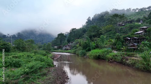 Aerial video showing mountains and morning mist in a rural village in Nan Province, northern Thailand.

