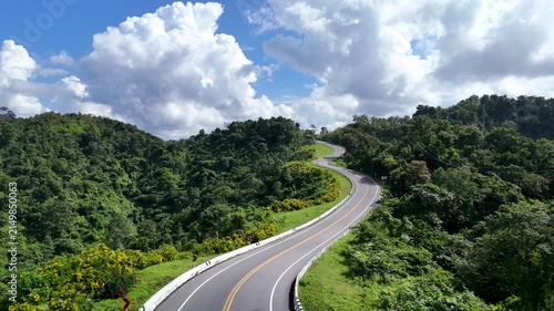 Aerial view of car driving on beautiful steep curved road (look like number 3) on the high mountain in Nan province, Thailand.
