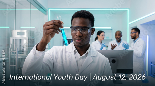 Young Black Scientist Holding Glowing Test Tube in Modern Lab with Diverse Team Celebrating International Youth Day