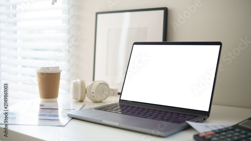 Fotografía Modern home office workspace with laptop, calculator, financial documents, headphones, and coffee, representing remote work, budgeting, and personal finance
