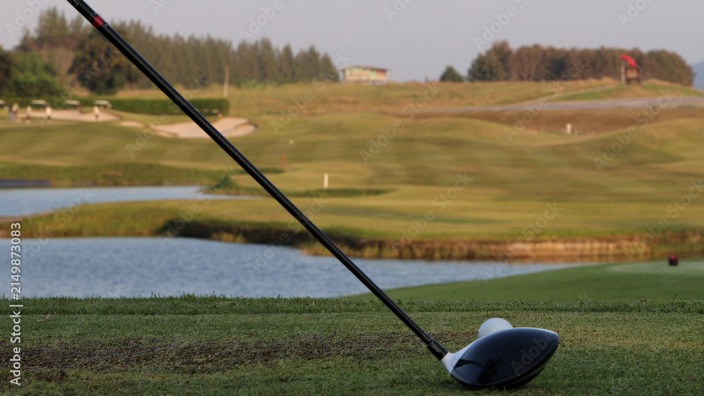 Naklejka premium Close Up of Golf Driver Behind Ball on Tee Box