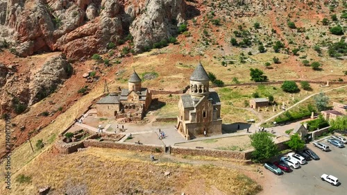 Bird's-eye shot of Noravank monastery perched on hilly landscape