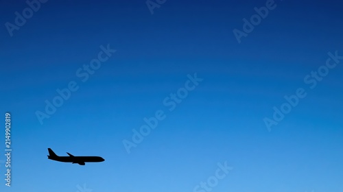 airline. Aircraft silhouette in the distance against a clear sky with simple natural composition. mobility guides, transit brochures, designed for mobility and urban transit guides.