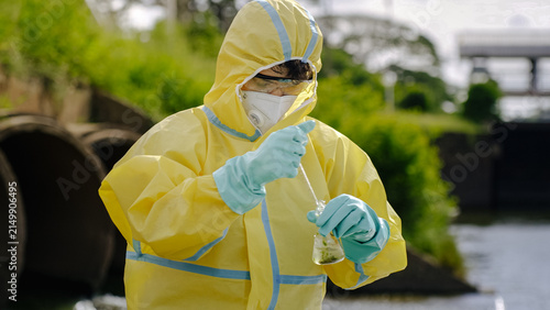 Konstfotografi Hazmat Scientist Testing Wastewater with Pipette by Drainage