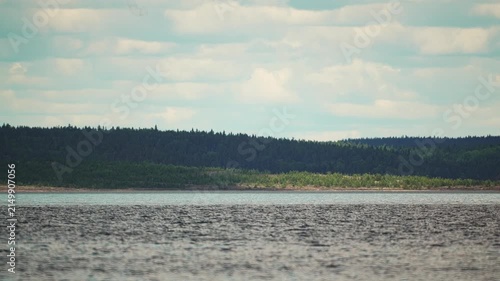 cloud shadows moving across the forest and the rocky seashore, time-lapse video