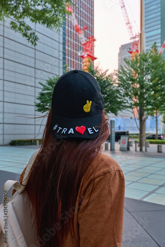 A traveler girl with a suitcase in the city