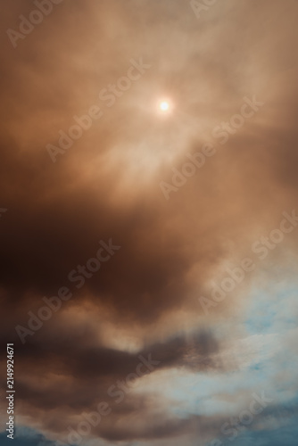 Sun glowing through a dense orange and brown smoke cloud caused by a massive forest wildfire in Deliblatska Pescara nature reserve. Deliblato, Serbia - August 7, 2026.
