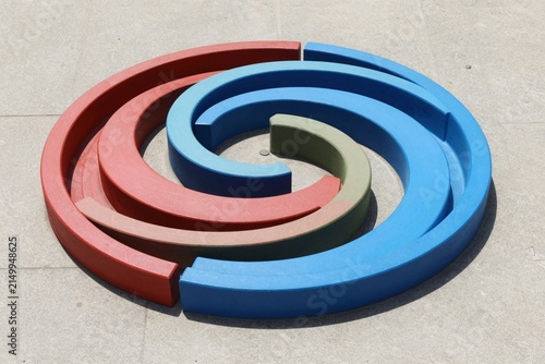 Colorful Spiral Sculpture on Concrete Surface