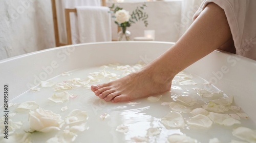 Soothing foot soak with rose petals in a tranquil spa setting promoting relaxation and personal wellness