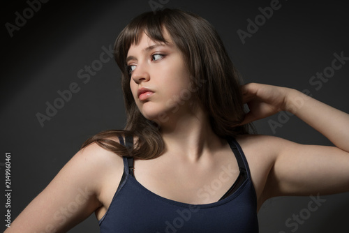 Beautiful teenage girl posing for beauty portrait on dark background