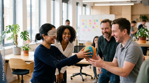 Diverse group of colleagues playing a blindfolded trust building game in a modern office.