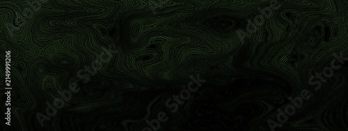 Dark abstract background with deep green foliage textures and heavy shadows creating a moody mysterious forest atmosphere