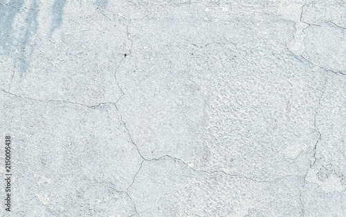 Obraz na płótnie A close-up image of a textured concrete surface showing fine cracks and a rough, weathered appearance with a muted color palette