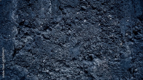 Dark navy blue grunge concrete wall texture with rough stone surface for modern industrial background