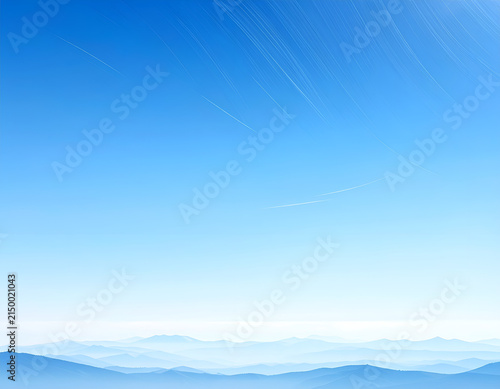 Vast Blue Sky Over Misty Mountain Range Horizon.