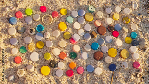 Canvas Print plastic bottle cap on sandy beach pollution, stop motion