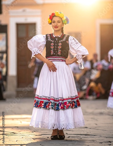 Young girl in traditional dress performing ballet.