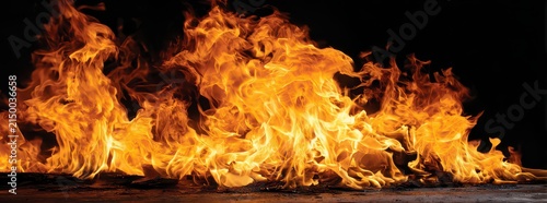 Intense Fire Flames with Fiery Orange and Yellow Hues Against a Dark Black Background Intense Heat and Destructive Energy Visualized