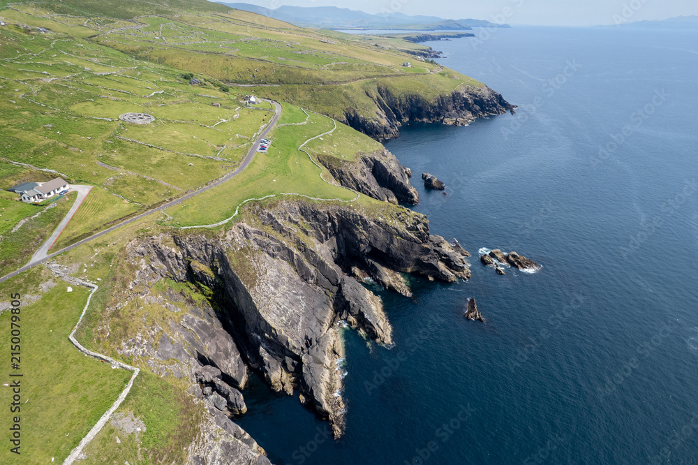Fototapeta premium Drone aerial scenery of Dramatic cliffs and fahan beehive huts. Slea head drive wild atlantic ocean way Ireland. Irish landscape