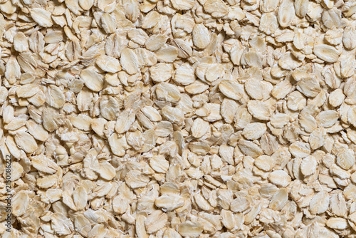Close-up background texture of dry raw oatmeal flakes full frame