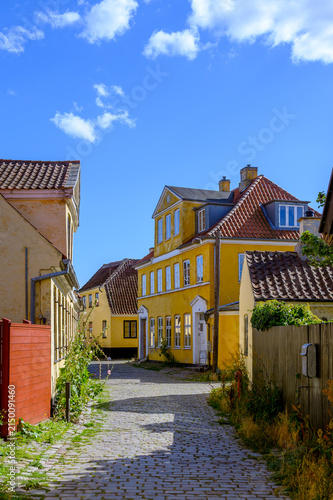 Yellow building along cobblestone street in old town of Dragør Denmark