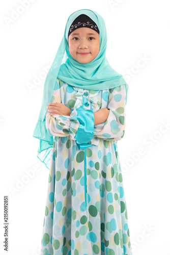Half length portrait of confident young Asian Muslim girl crossing arms isolated on white background.