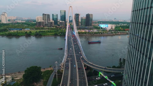 Aerial Shot of Ba Son Bridge Crossing Saigon River in Ho Chi Minh City
Shows evening road traffic commuting across the bridge connecting District 1 with the Thu Thiem urban area against a modern high-