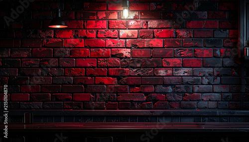 Dark red brick wall background with pendant lighting and empty bar counter top for product display
