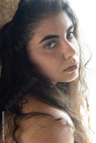 Young woman looking back with intense gaze