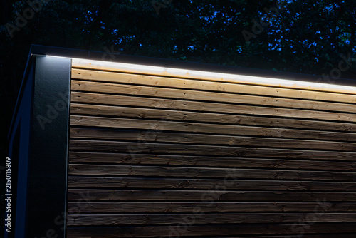 Illuminated wooden facade at night in the park