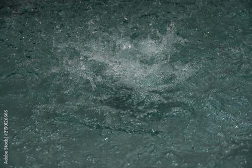 Obraz na płótnie Dynamic water splash with turbulent motion and bubbles