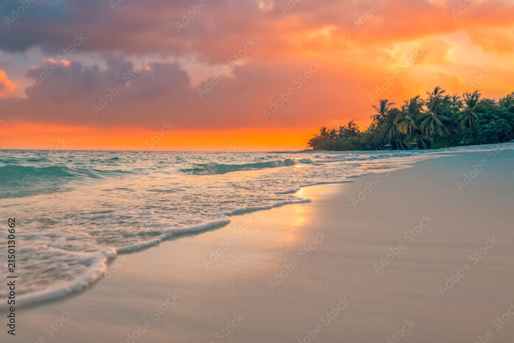 Obraz premium Tranquil waves sand dramatic orange sunset tropical beach palm silhouette glowing ocean stunning sky. Perfect summer travel landscape paradise. Warm romantic coastal getaway scenic nature background