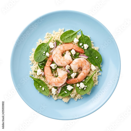 Shrimp couscous salad with spinach and feta, isolated on a light blue plate