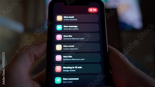 Two hands holding smartphone receiving many spam notifications at once
