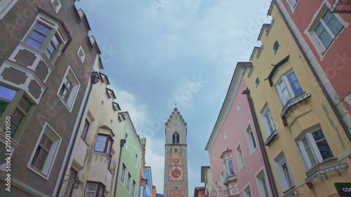 Passage between the colourful houses and the bell tower of Vipiteno Sterzing