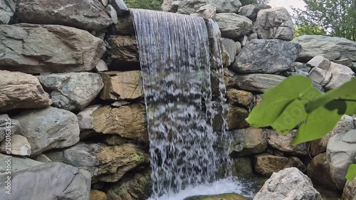 Powerful water flowing over mossy rocks at waterfall