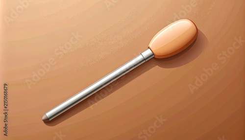 Isolated wooden spoon handle on brown background.
