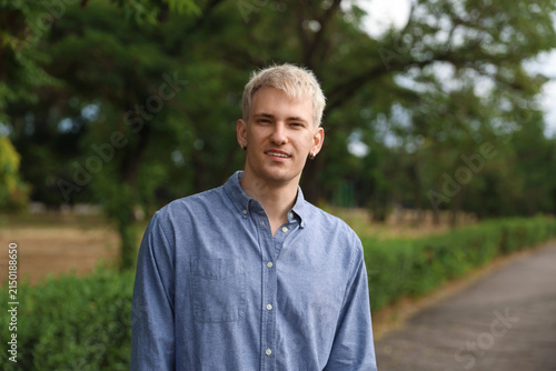 Portrait of smiling man wearing shirt in park