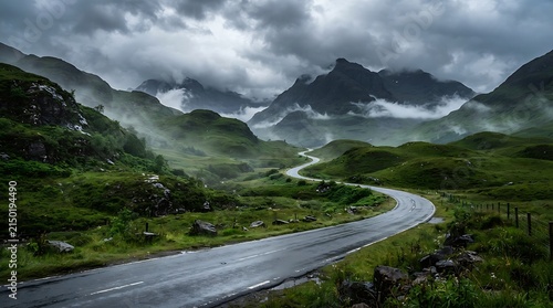Winding road through a misty mountain valley
