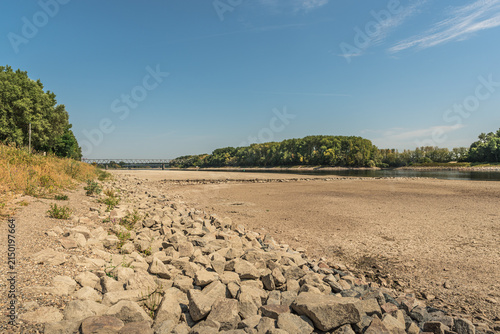Dried up section of the Rhine River with stones and gravel during extreme summer drought, Germersheim, Germany
