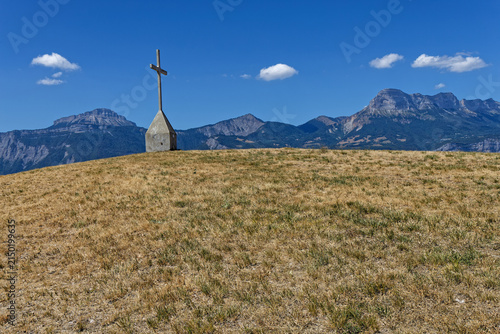 A panorama opens on the summits of the Chartreuse, Chamechaude and the Dent de Crolles from the Croix de Revollat